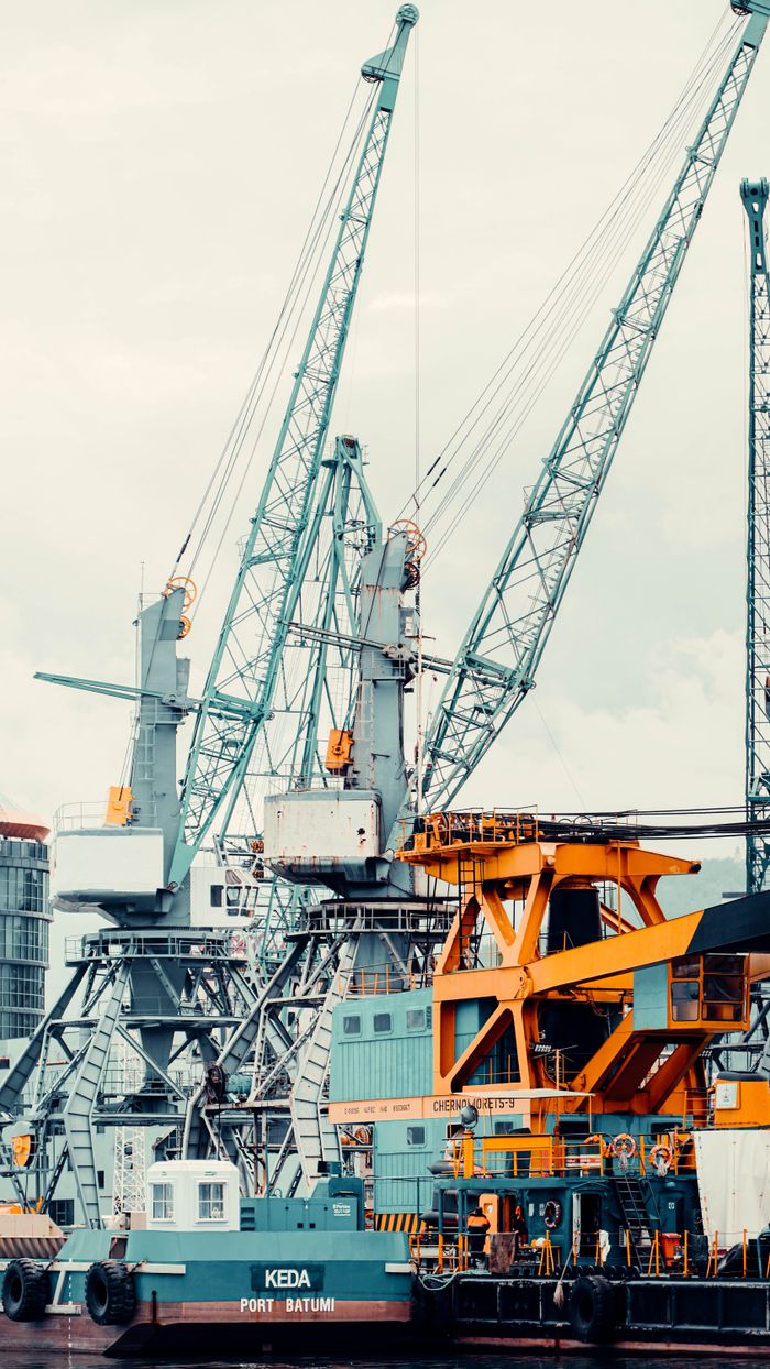 View of towering cranes and machinery at Batumi port, highlighting industrial activity.